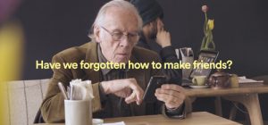 An older man using a phone - text reads: Have we forgotten how to make friends?'