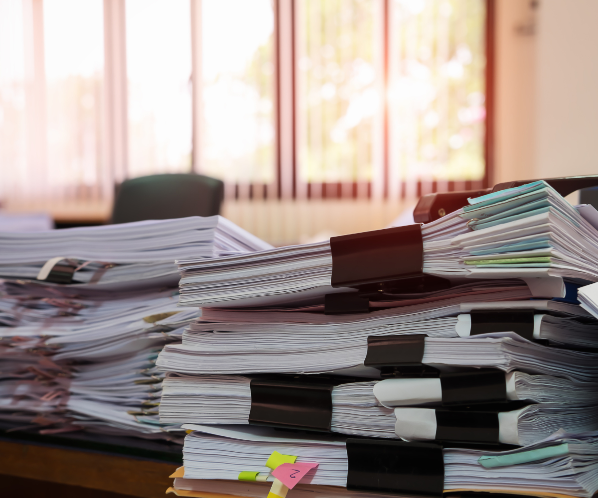 A large pile of notebooks and papers