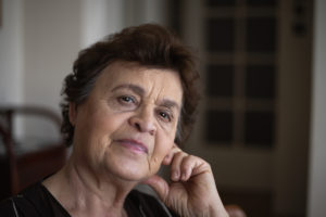 An older women looks pensively at the camera