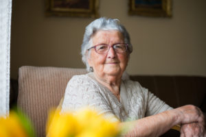 An older women, smiling at the camera