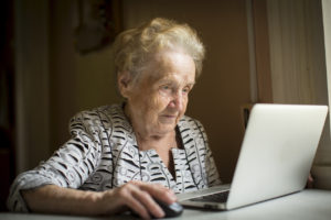 An older woman using a computer